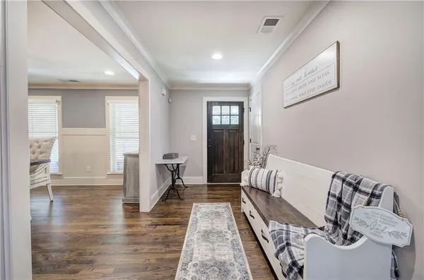 a living room with furniture wooden floor and a fireplace