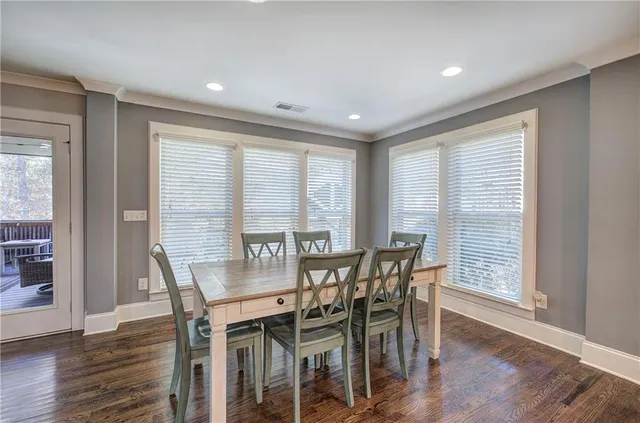a living room with furniture and large windows