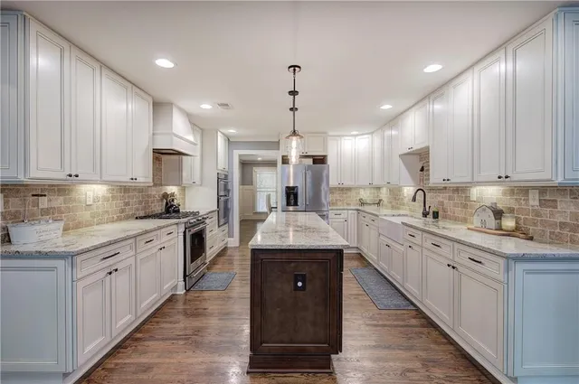 a patio with a table and chairs under an umbrella