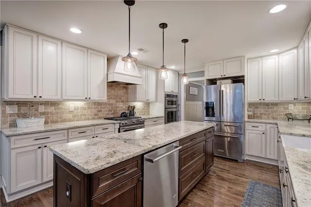 a view of walk in closet with clothes