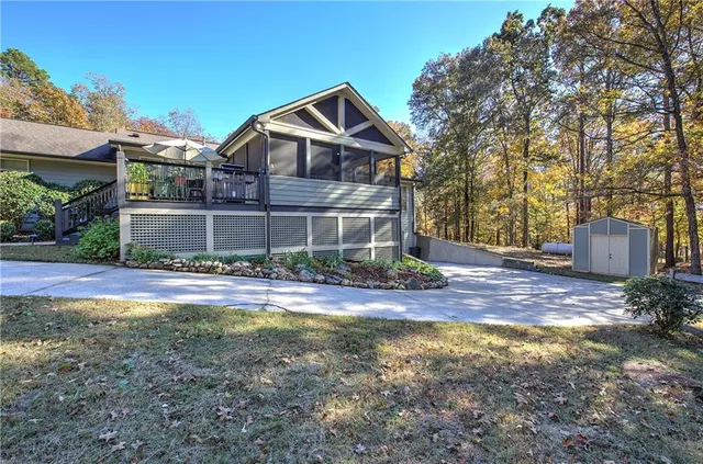 a view of a hallway with wooden floor and a kitchen