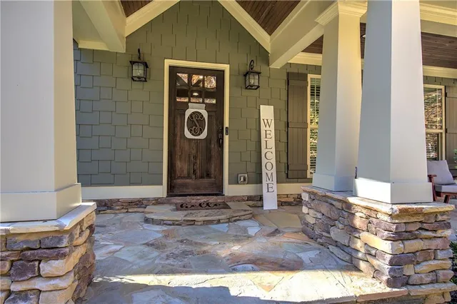 a view of a hallway with wooden floor and windows