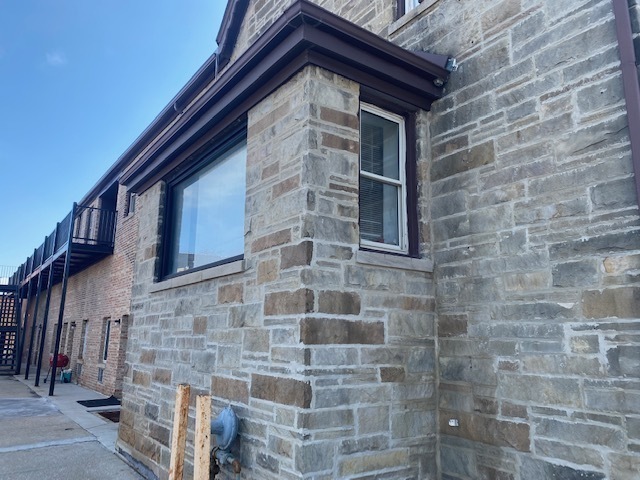 171 25th Avenue, Unit 8 Melrose Park, IL 60160 - Photo 15 of 16 a brick building with a small yard