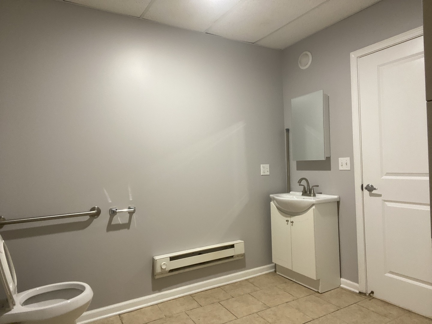 171 25th Avenue, Unit 8 Melrose Park, IL 60160 - Photo 8 of 16 a bathroom with a sink a toilet and a mirror