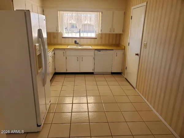 a kitchen with stainless steel appliances a refrigerator sink and cabinets