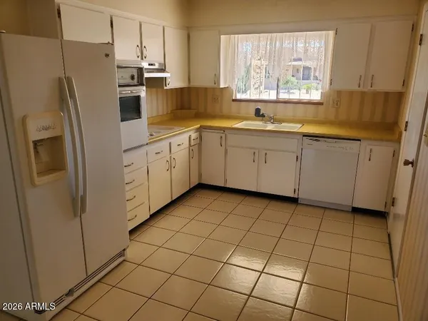 a kitchen with stainless steel appliances a refrigerator sink and microwave