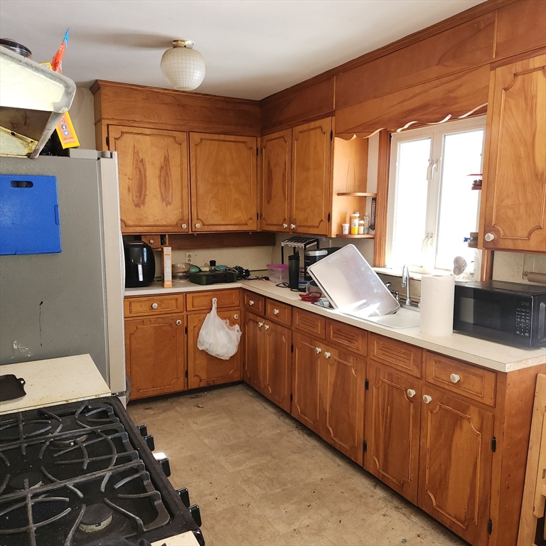 514 Dewey Street West Springfield, MA 01089 - Photo 13 of 42 a kitchen with sink cabinets and window