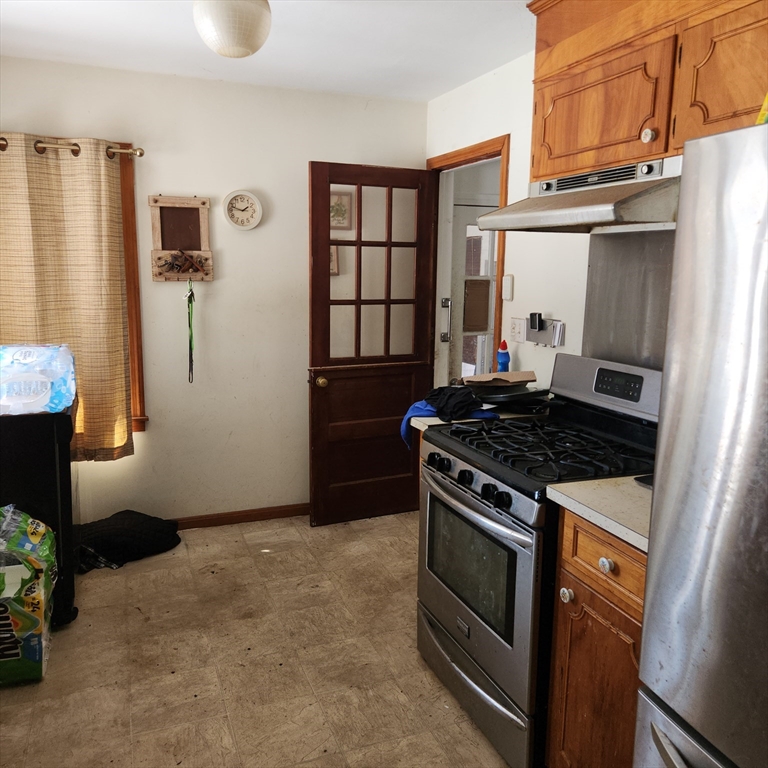 514 Dewey Street West Springfield, MA 01089 - Photo 15 of 42 a kitchen with granite countertop a stove and a refrigerator