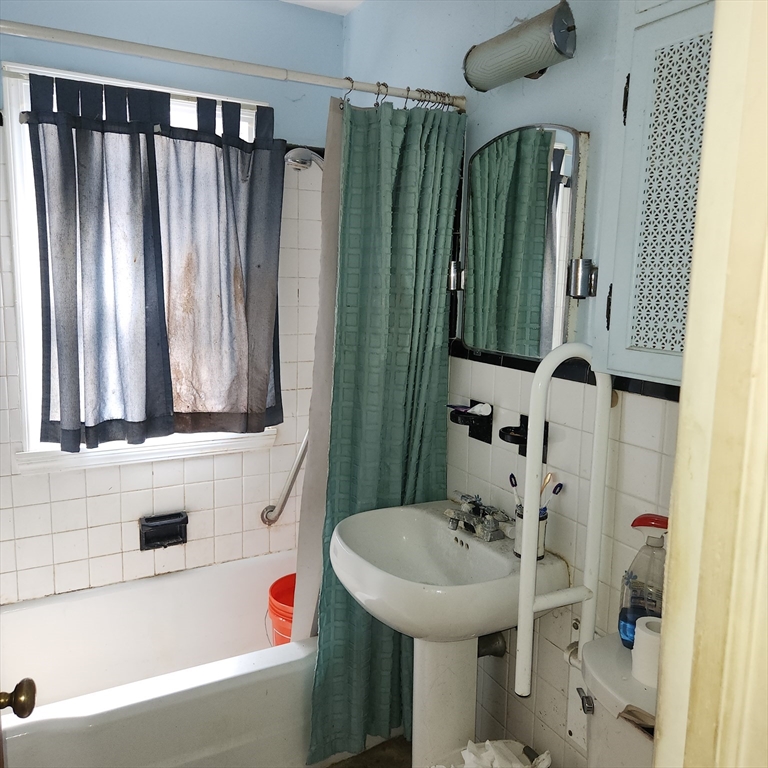 514 Dewey Street West Springfield, MA 01089 - Photo 17 of 42 a bathroom with a sink a toilet and a mirror