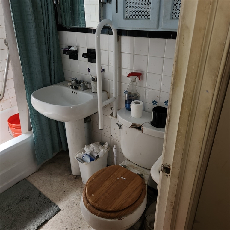 514 Dewey Street West Springfield, MA 01089 - Photo 21 of 42 a bathroom with a toilet sink and mirror