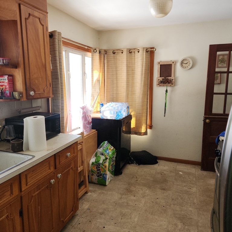 514 Dewey Street West Springfield, MA 01089 - Photo 8 of 42 a very nice looking room with a large window and a potted plant