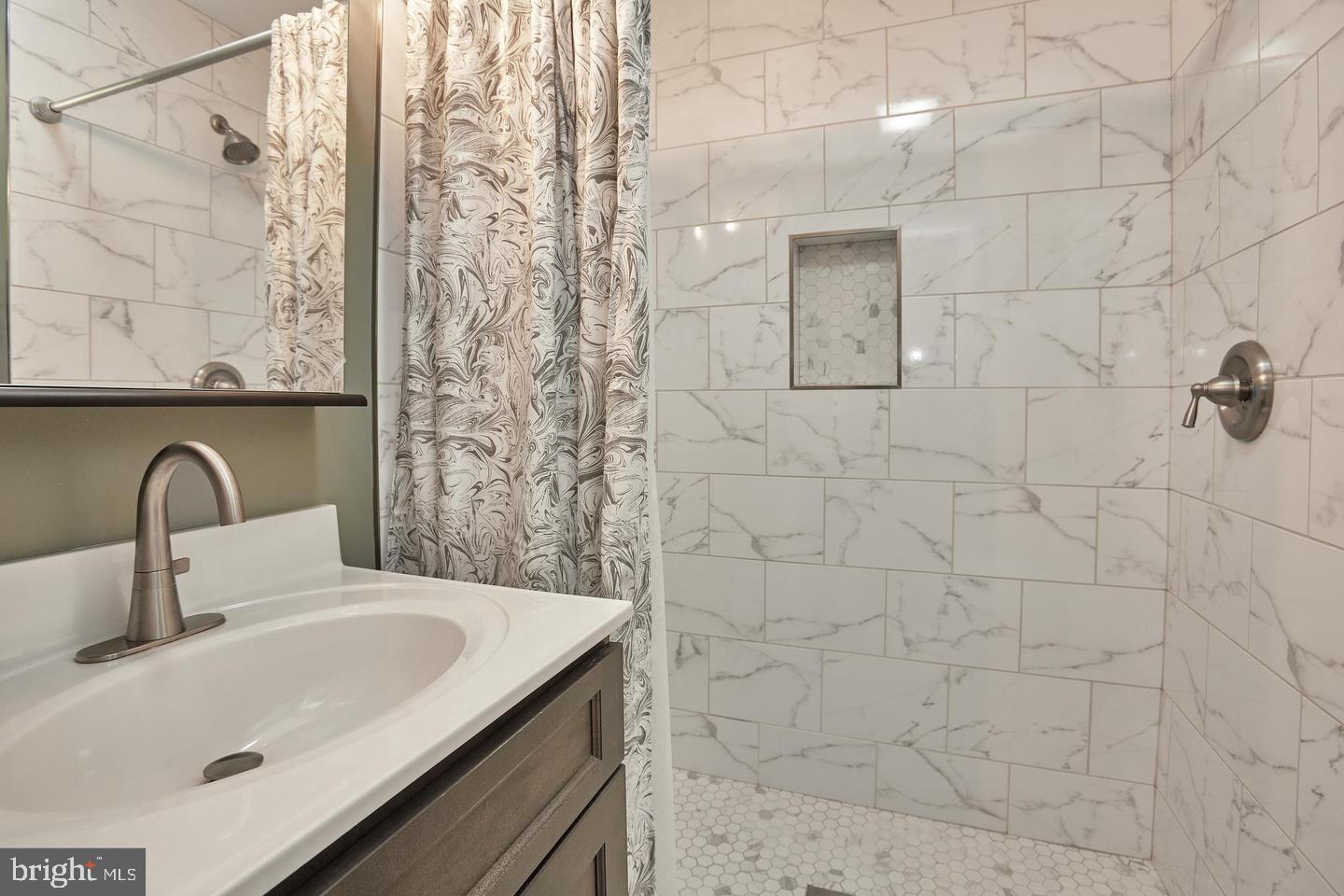 1007 Venice Drive Silver Spring, MD 20904 - Photo 21 of 39 a bathroom with a sink and mirror