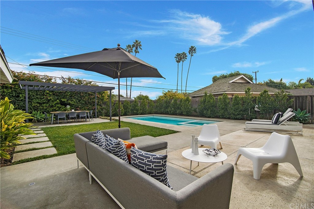 2940 Java Road Costa Mesa, CA 92626 - Photo 24 of 28 a view of a roof deck with couches under an umbrella