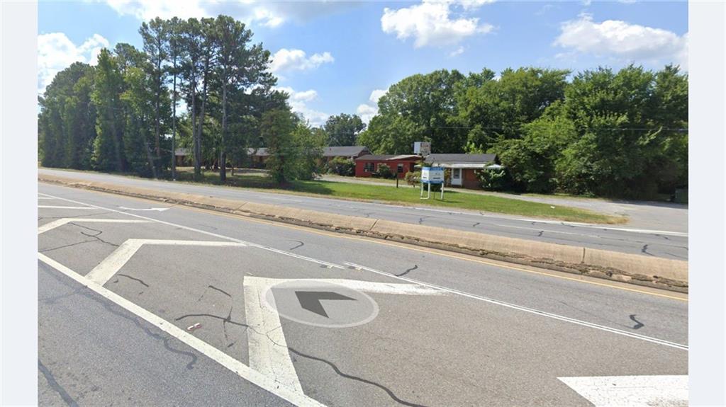 1022 Cassville Road Southeast Cartersville, GA 30120 - Photo 6 of 8 a view of a house with a yard and a large trees