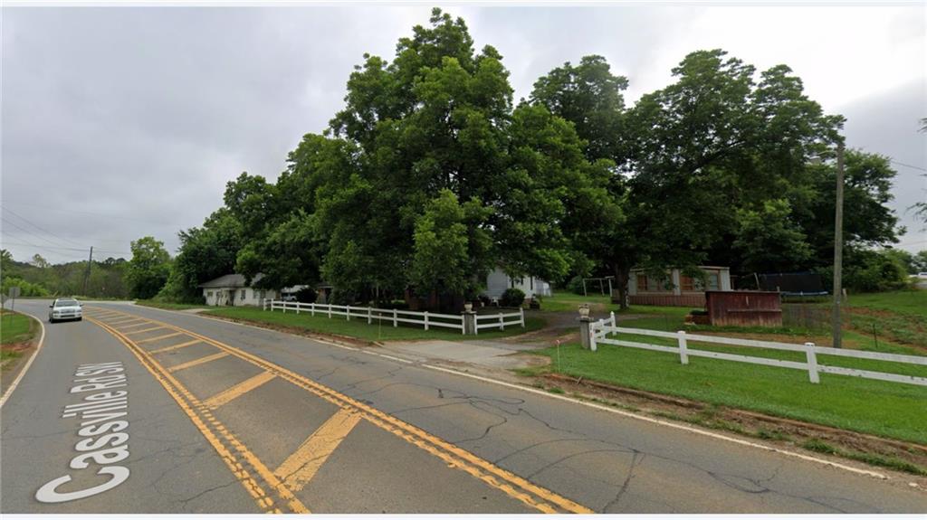 1022 Cassville Road Southeast Cartersville, GA 30120 - Photo 7 of 8 a view of a tennis ground with large trees