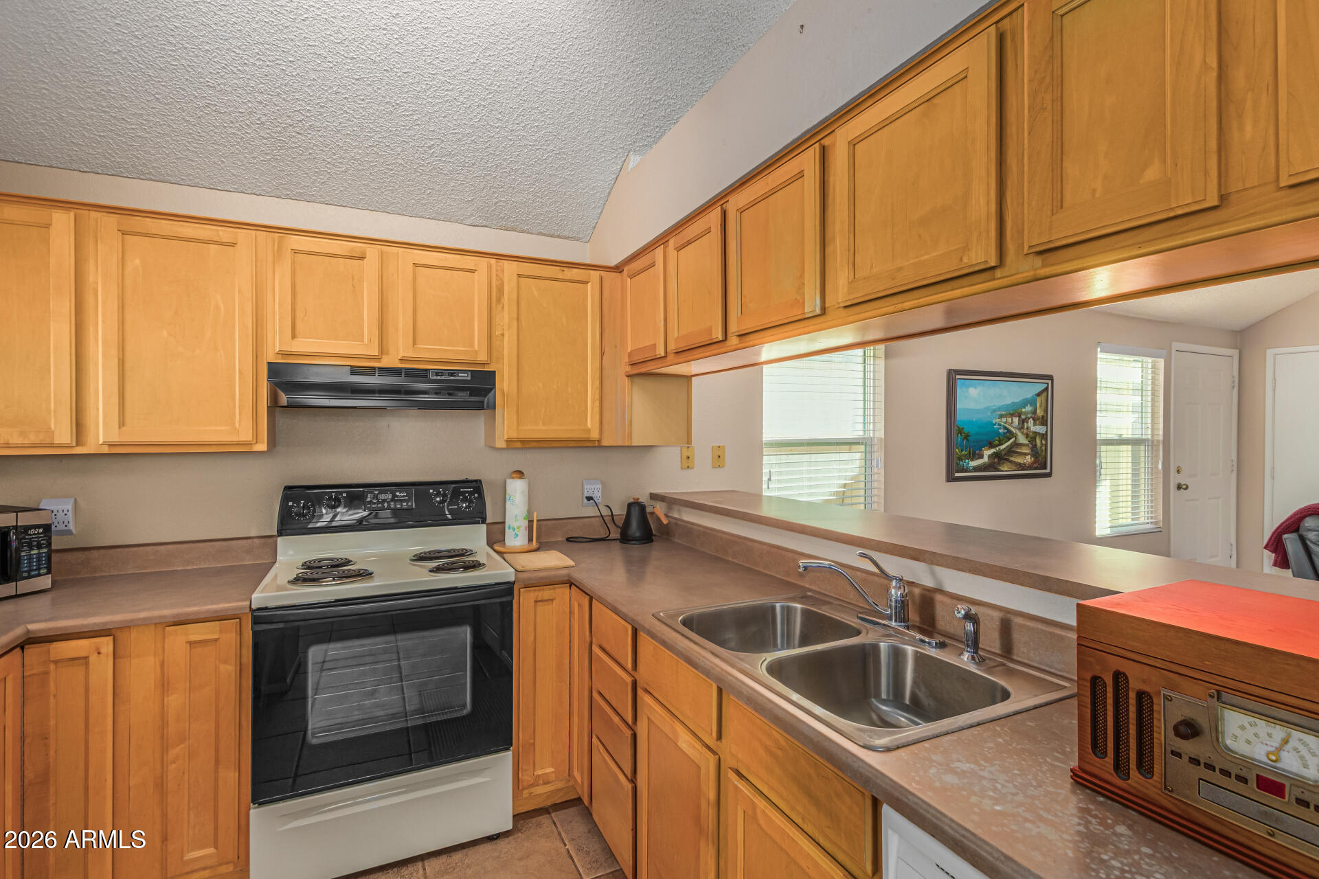 3904 West Butler Street Chandler, AZ 85226 - Photo 16 of 30 a kitchen with granite countertop a sink a stove and cabinets