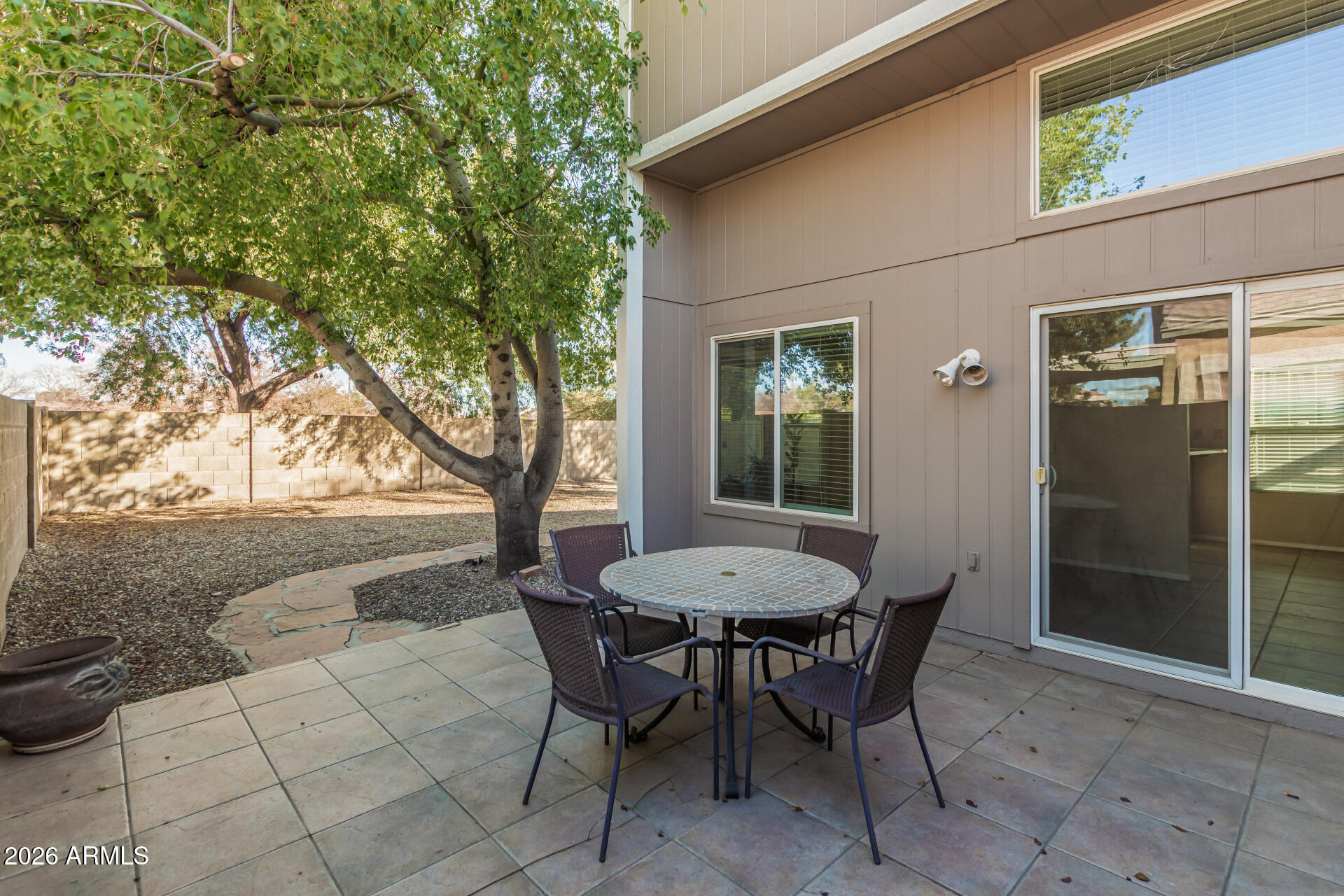 3904 West Butler Street Chandler, AZ 85226 - Photo 26 of 30 a view of a patio with table and chairs and potted plants