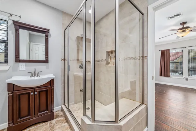 a bathroom with a sink a mirror and shower