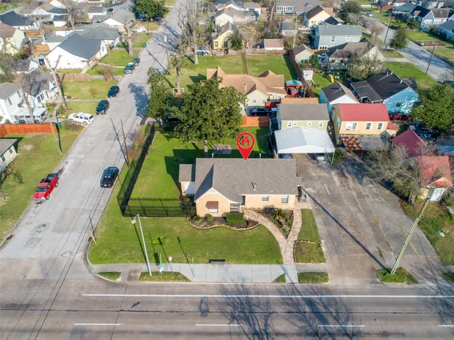 an aerial view of a house with a garden and potted plants