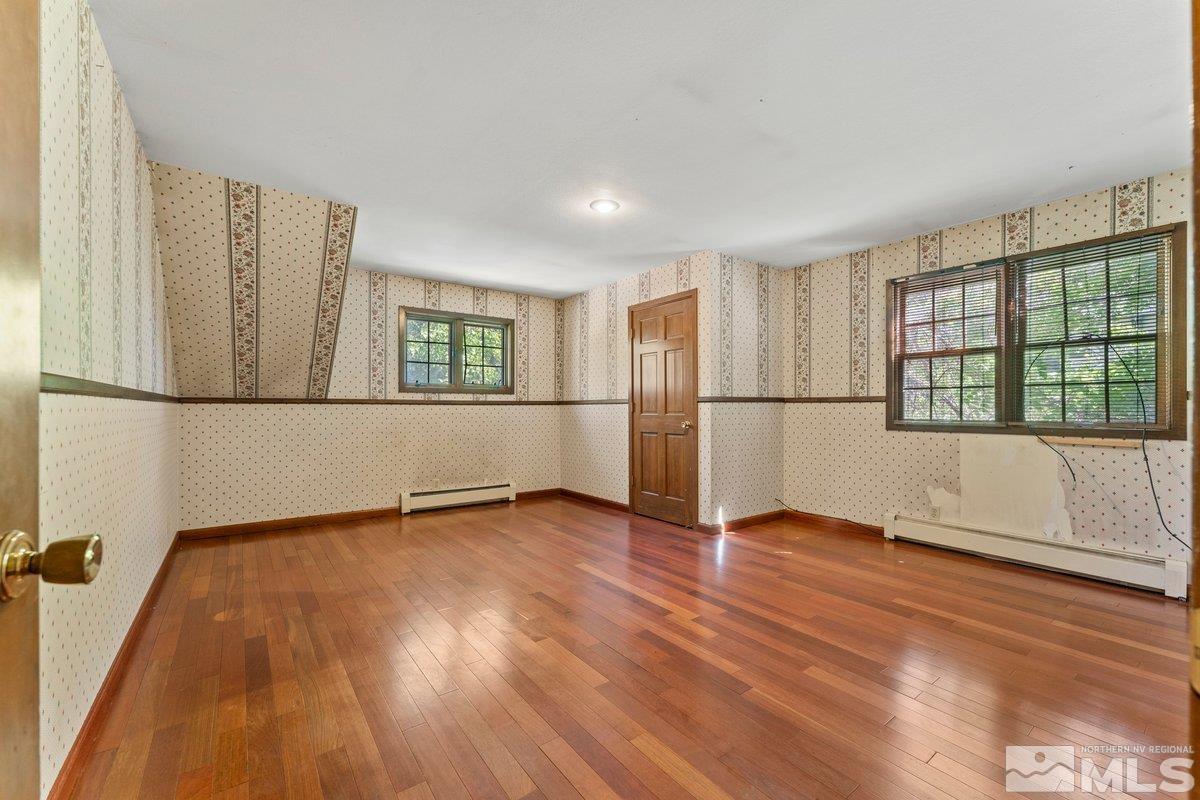 1120 Monroe Street Reno, NV 89509 - Photo 18 of 27 an empty room with wooden floor and windows