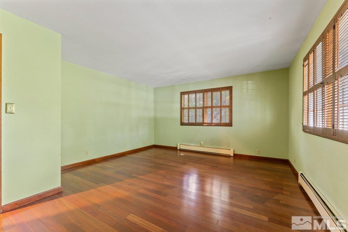 1120 Monroe Street Reno, NV 89509 - Photo 19 of 27 an empty room with wooden floor and windows