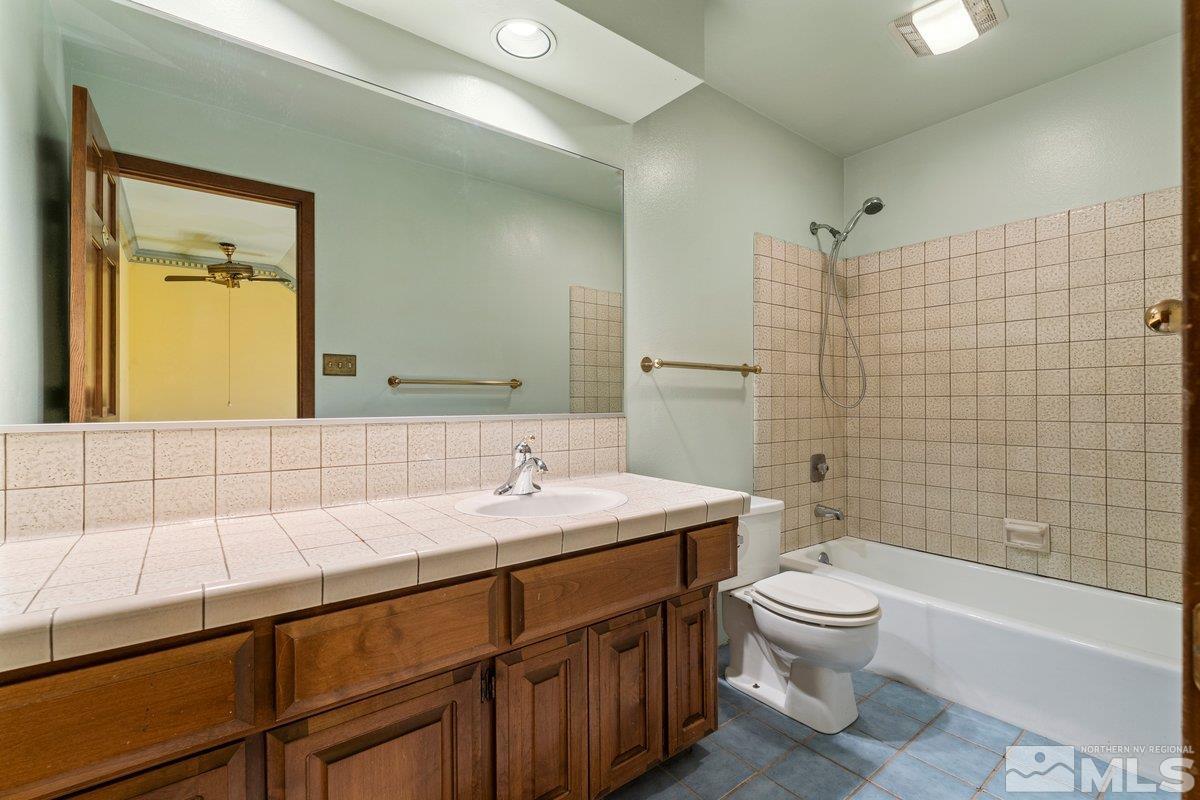 1120 Monroe Street Reno, NV 89509 - Photo 20 of 27 a bathroom with a sink a toilet and shower