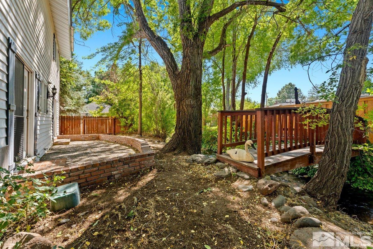 1120 Monroe Street Reno, NV 89509 - Photo 25 of 27 a view of backyard with a garden and trees