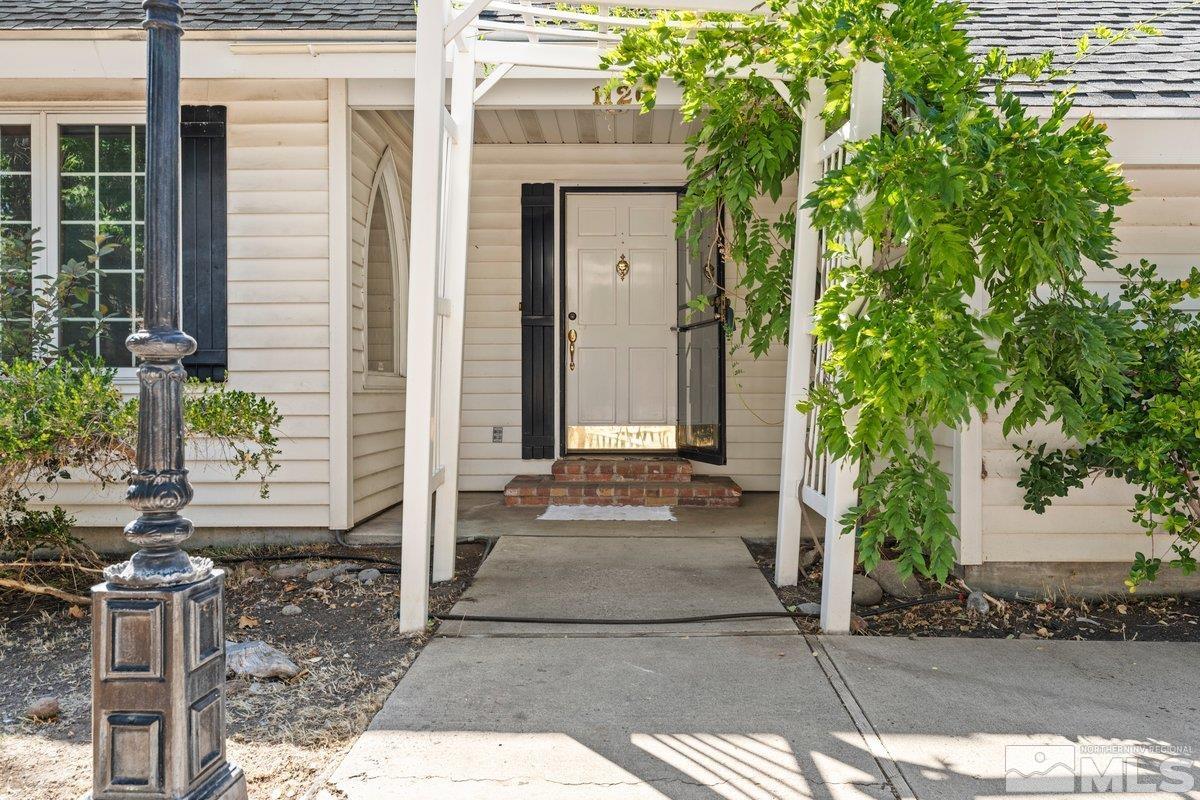 1120 Monroe Street Reno, NV 89509 - Photo 3 of 27 a front view of a house with garden