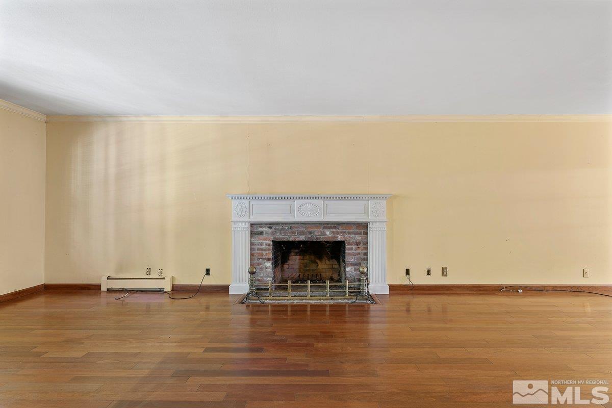1120 Monroe Street Reno, NV 89509 - Photo 6 of 27 a view of an empty room with wooden floor and a fireplace