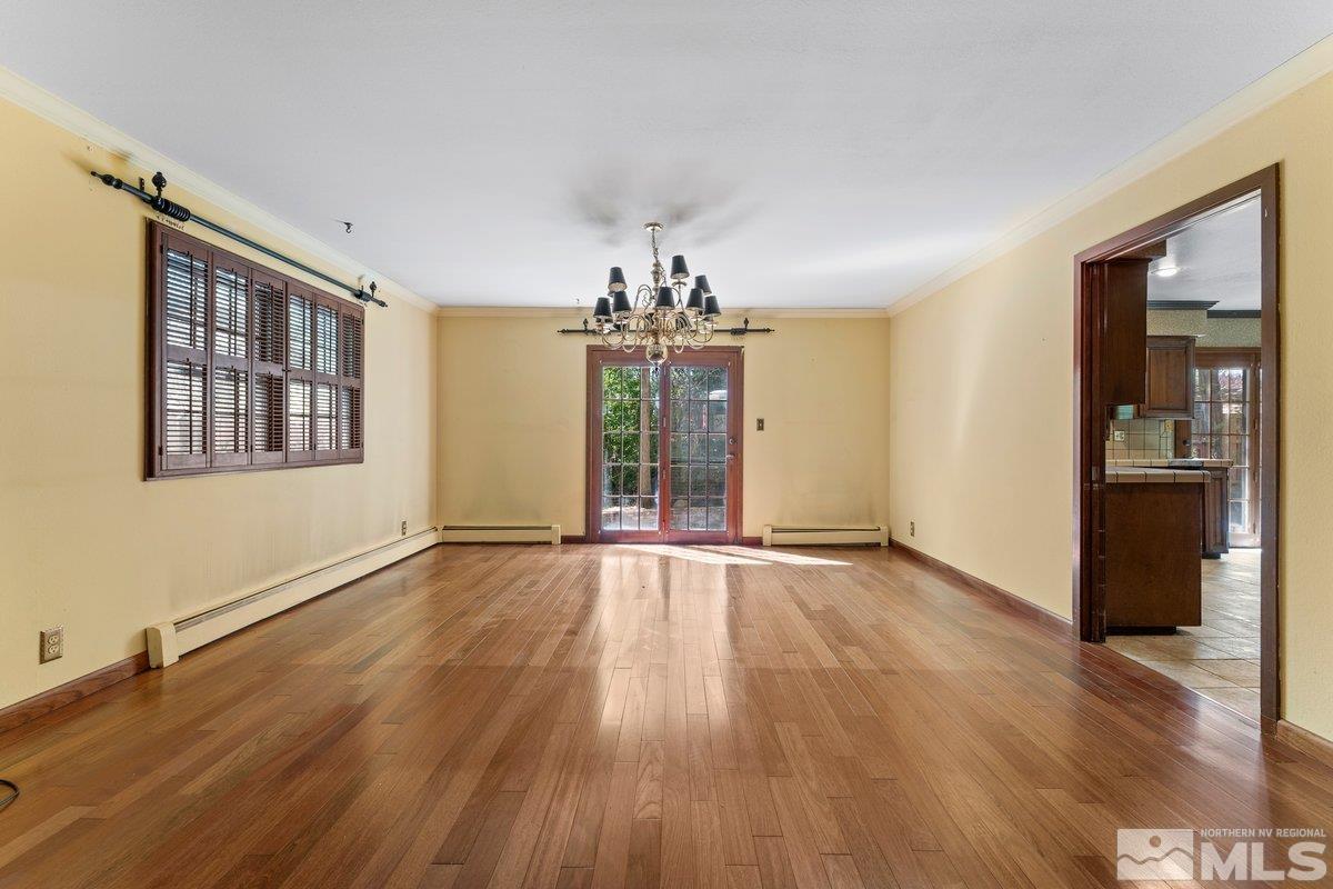 1120 Monroe Street Reno, NV 89509 - Photo 9 of 27 wooden floor in an empty room with a window