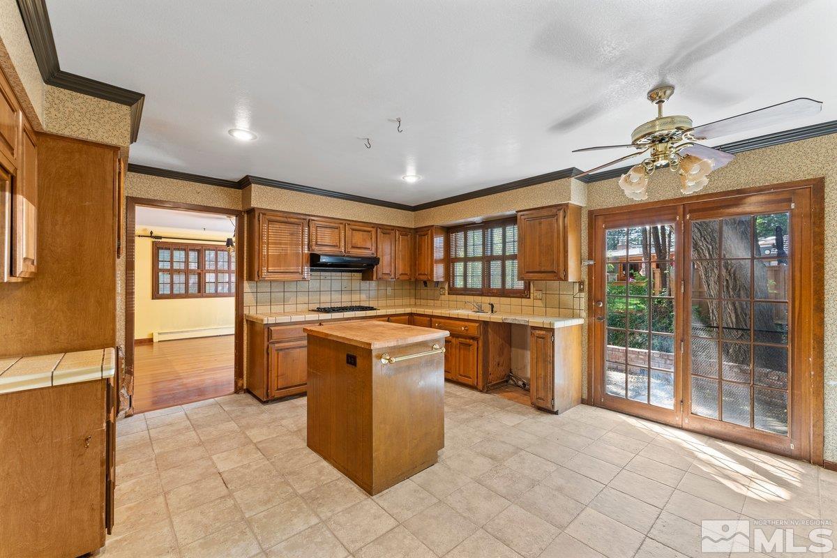1120 Monroe Street Reno, NV 89509 - Photo 10 of 27 a large kitchen with stainless steel appliances granite countertop a stove and cabinets