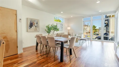 a view of a dining room with furniture and wooden floor