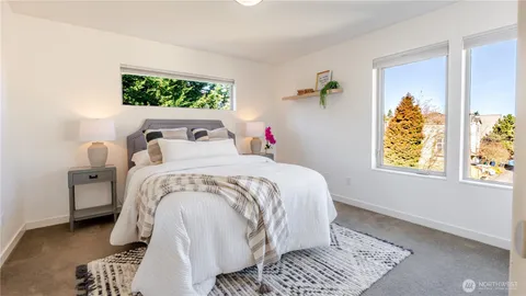 a bed sitting in a bedroom next to a window