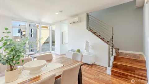 a dining room with furniture and wooden floor