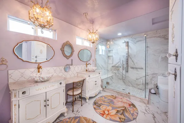 a view of empty room with wooden floor and bathroom