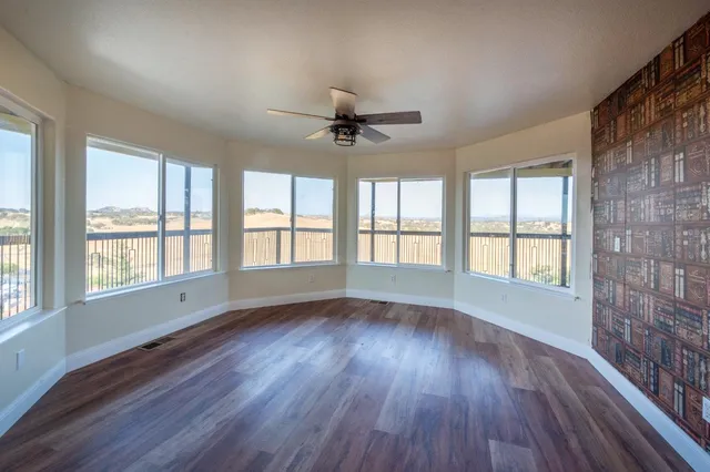an empty room with a window and closet