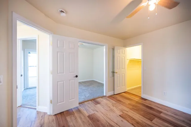 a balcony with wooden floor table and chairs