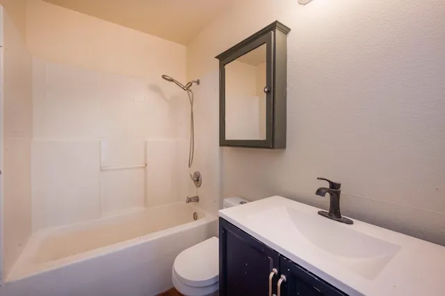 a view of a roof deck with lawn chairs and wooden floor