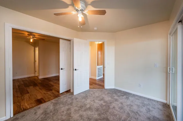 a view of a balcony with wooden floor and fence