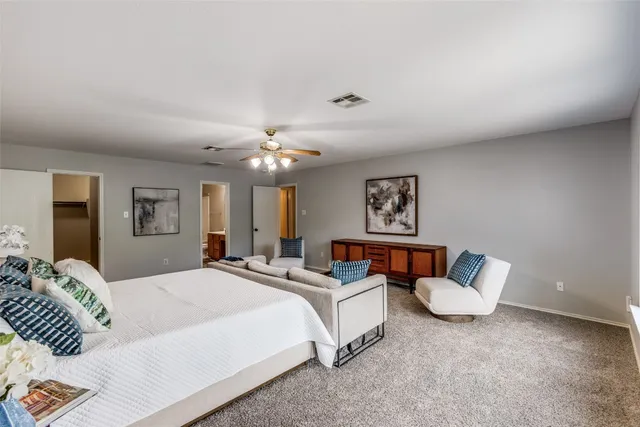 a bedroom with bed and a couch