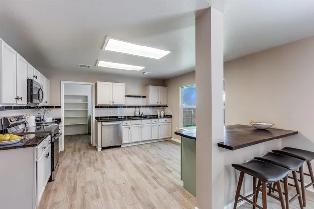 a kitchen with stainless steel appliances granite countertop a stove and a refrigerator