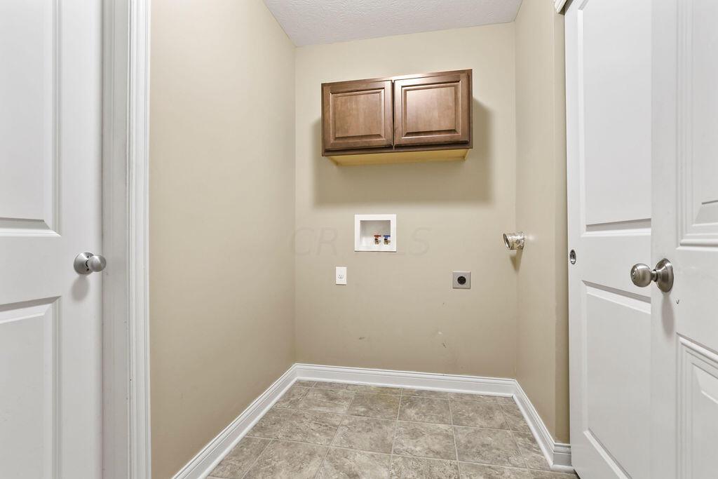 6163 Jennis Road Westerville, OH 43081 - Photo 21 of 44 • Neutral vinyl flooring
• Tan painted walls
• Ceiling light
• Wall cabinets
• Electric dryer hookup