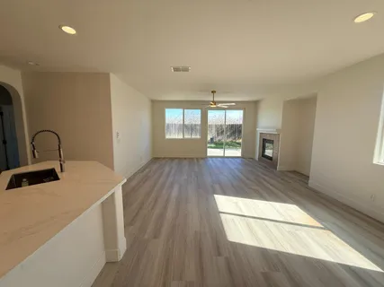 a view of a kitchen with wooden floor and electronic appliances