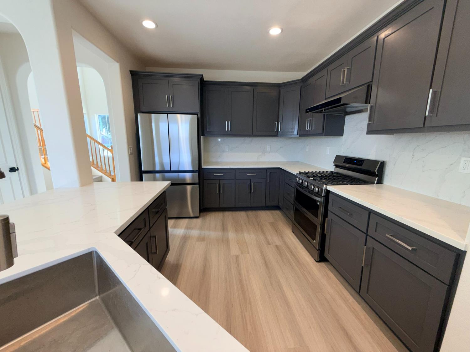 1977 Lemon Avenue Madera, CA 93637 - Photo 17 of 17 a kitchen with stainless steel appliances a stove a sink and a refrigerator