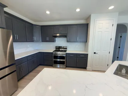 a kitchen with a refrigerator and a sink