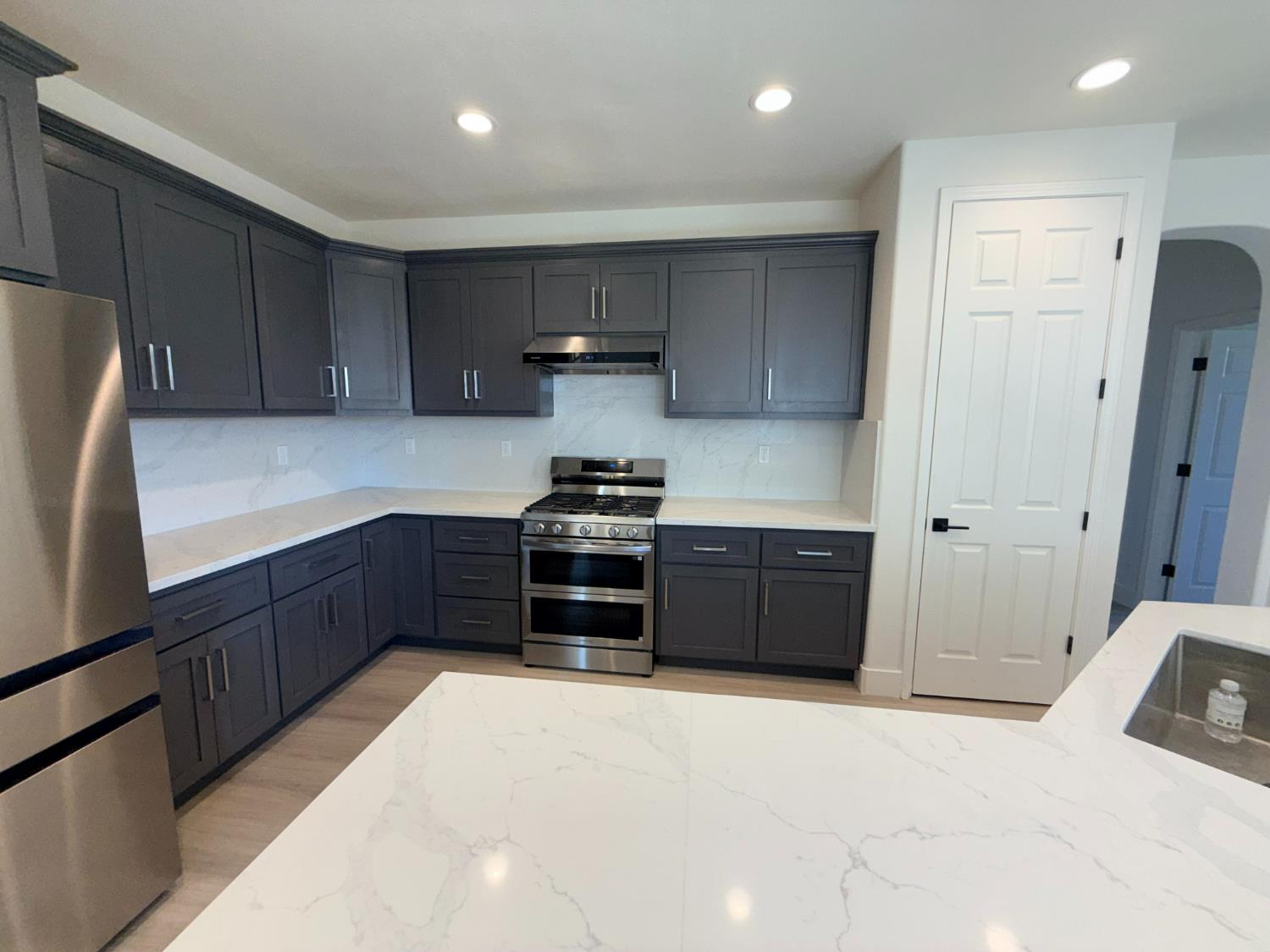 1977 Lemon Avenue Madera, CA 93637 - Photo 2 of 17 a kitchen with a refrigerator and a sink