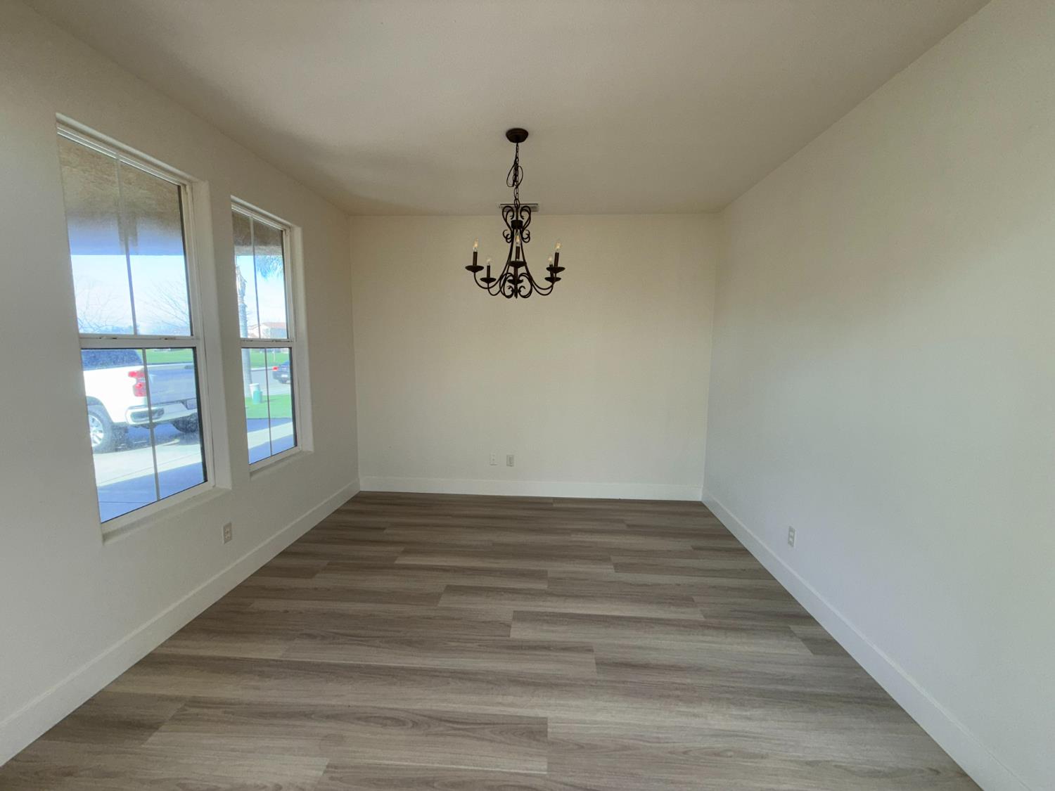 1977 Lemon Avenue Madera, CA 93637 - Photo 4 of 17 a view of empty room with wooden floor and fan