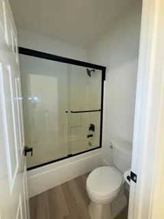 a bathroom with a toilet and a shower