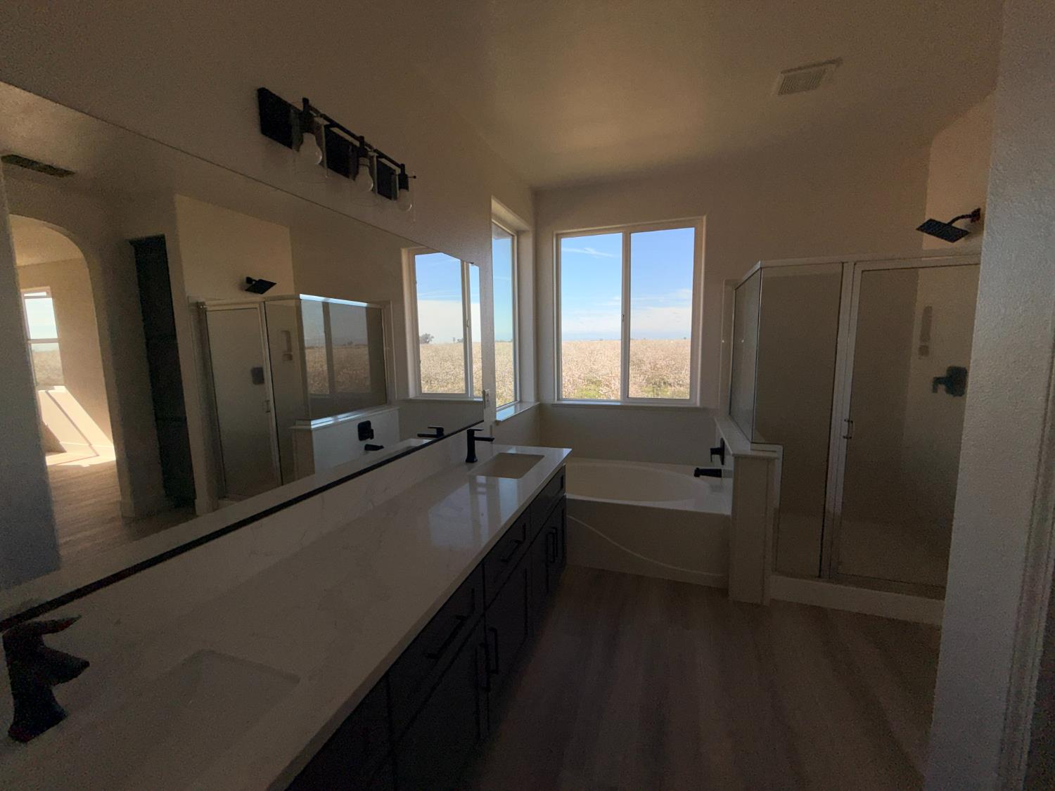 1977 Lemon Avenue Madera, CA 93637 - Photo 7 of 17 a bathroom with a double vanity sink and mirror with bathtub