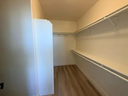 a view of a room with wooden floor